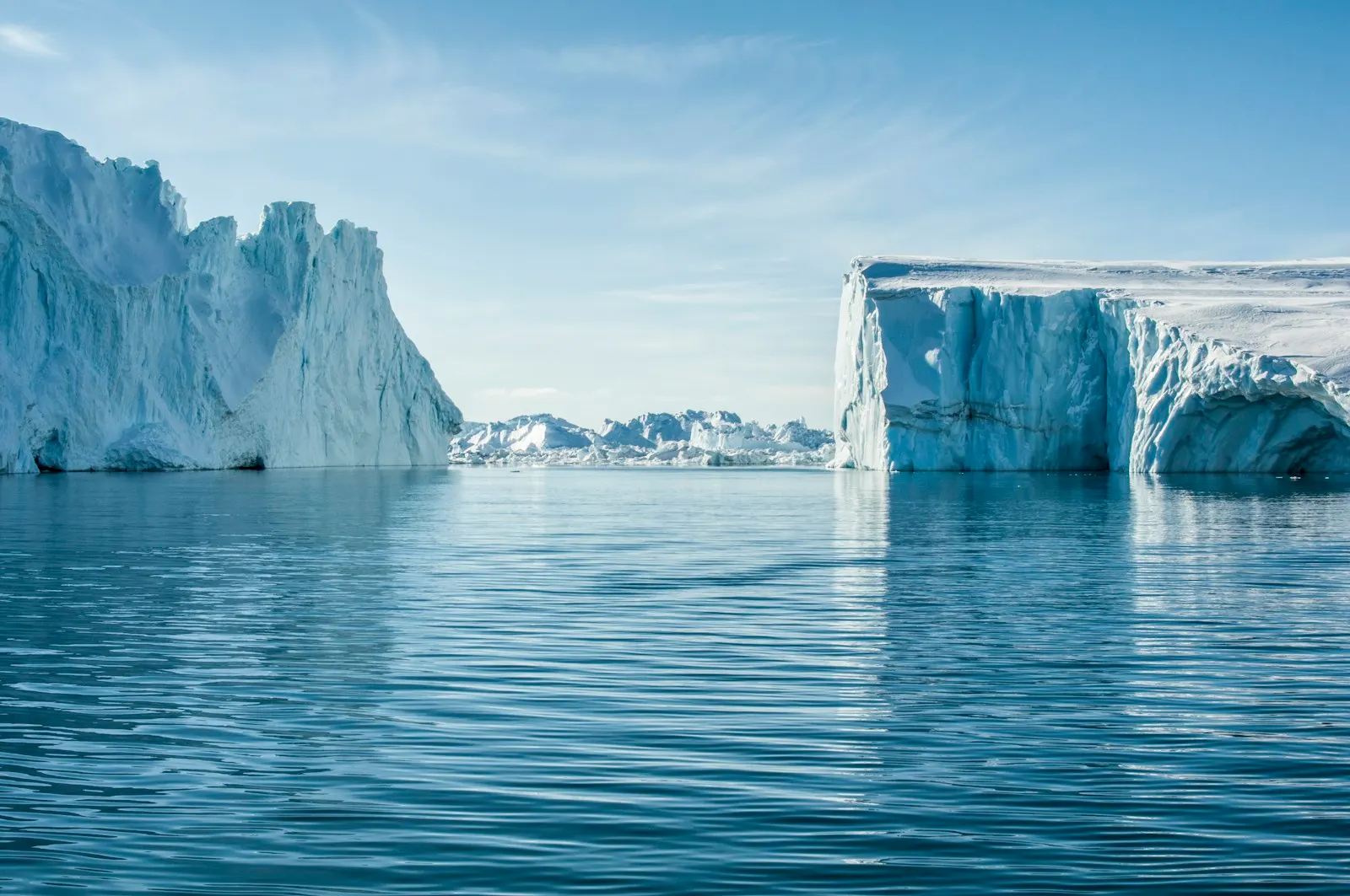 Greenland — icebergs in Ilulissat Icefjord under blue sky
